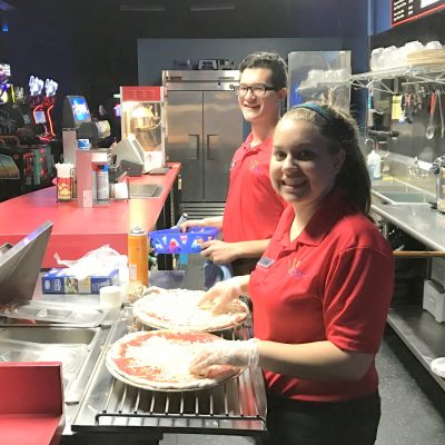 Two of our party hosts making pizzas for a birthday party
