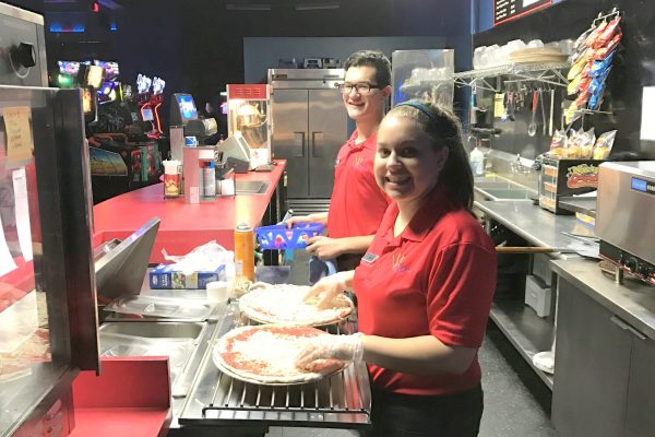 Two of our party hosts making pizzas for a birthday party